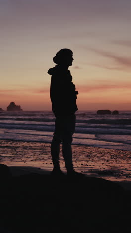 silhouette of a person at sunset on the beach