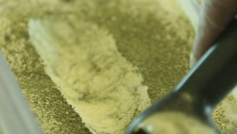 close up shot of pistachio ice cream being scooped