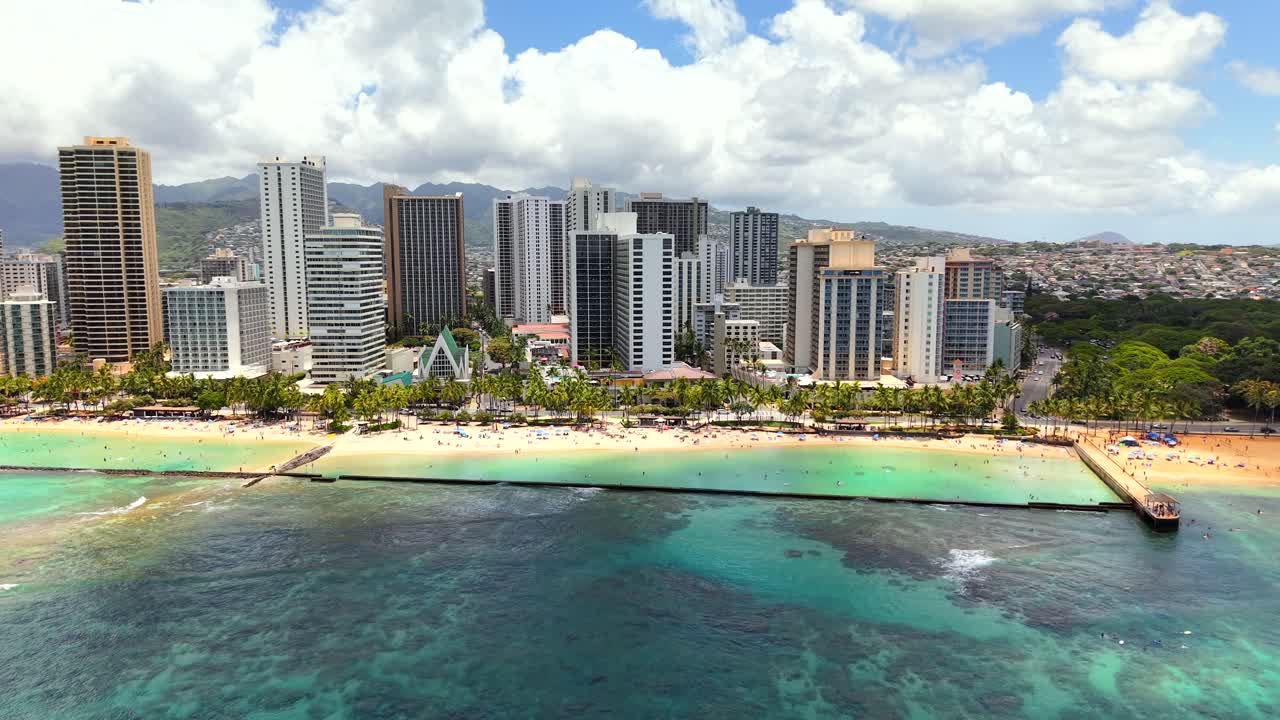 Sunny tropical getaway with people relaxing on Waikiki Beach