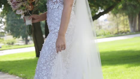 bride standing beautifully in wedding dress