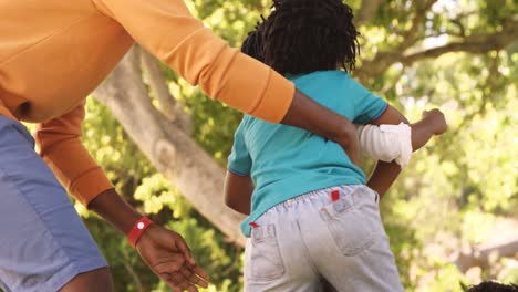 Close-up-of-cute-family-is-playing-rugby-in-a-park-