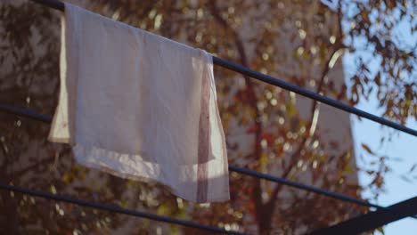 white cloth hanging on a clothesline low angle