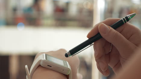 woman using smartwatch in city street