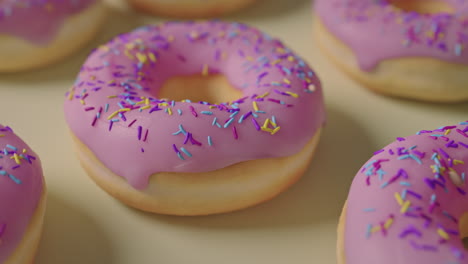 pink glaze donuts on a yellow background