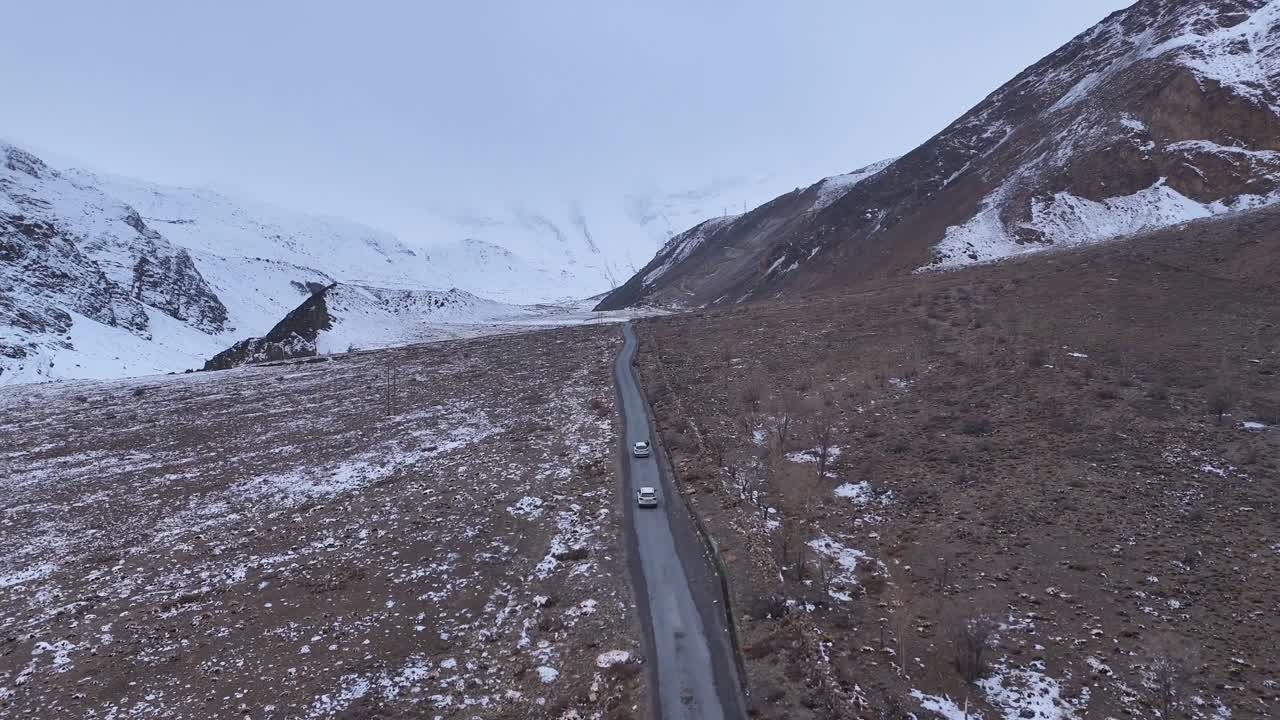 Snowy Mountain Road with Cars