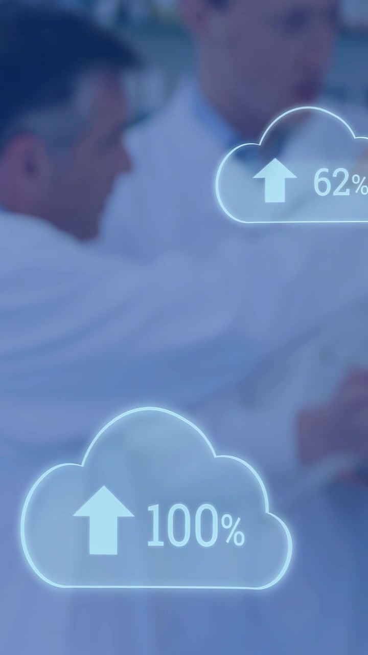 Vertical video: Lab team checking data and gesturing as lower cloud HUD nearing 100% in blurred lab
