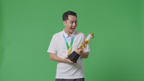 man holding trophy and medal