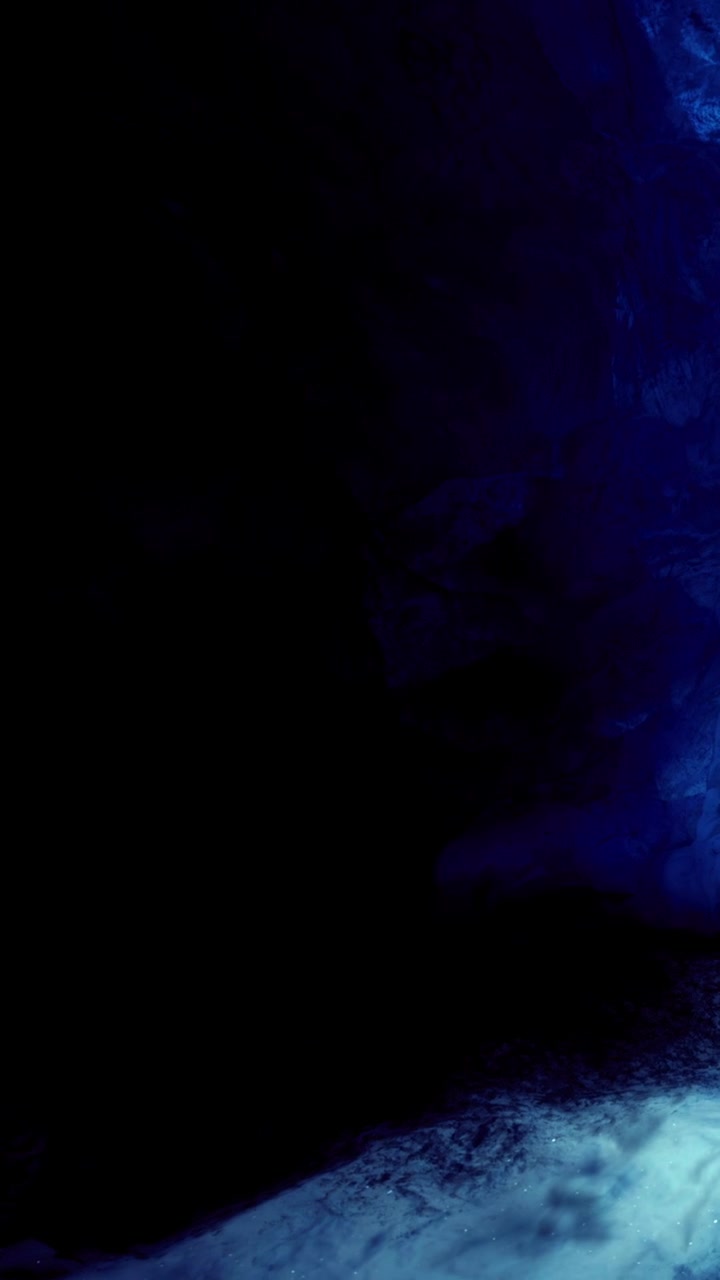 Colorful light shines on rocks in a cave during evening exploration time