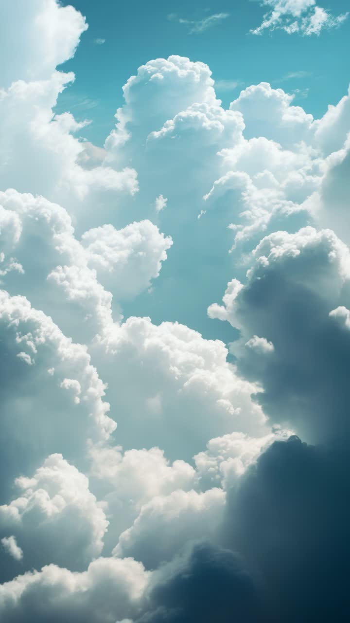 A breathtaking video still of towering cumulus clouds against a blue sky, captured from a low angle