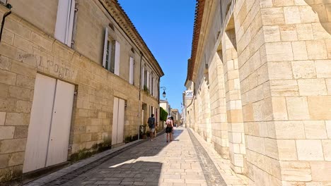 people walking down a charming stone street