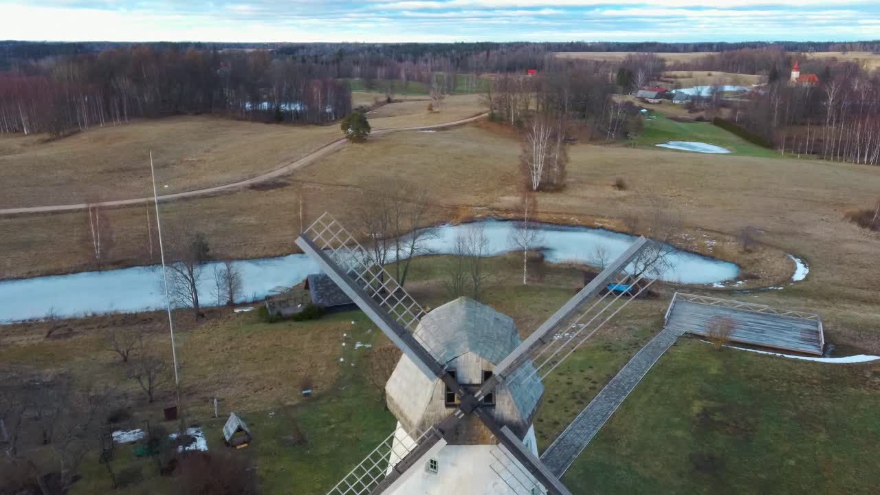 Old Araisi Windmill in Latvia Aerial Shot From Above. Winter Day at Sunrise. This Is the Only Windmill in Latvia at Working Order Built in 1852. 4K Shot