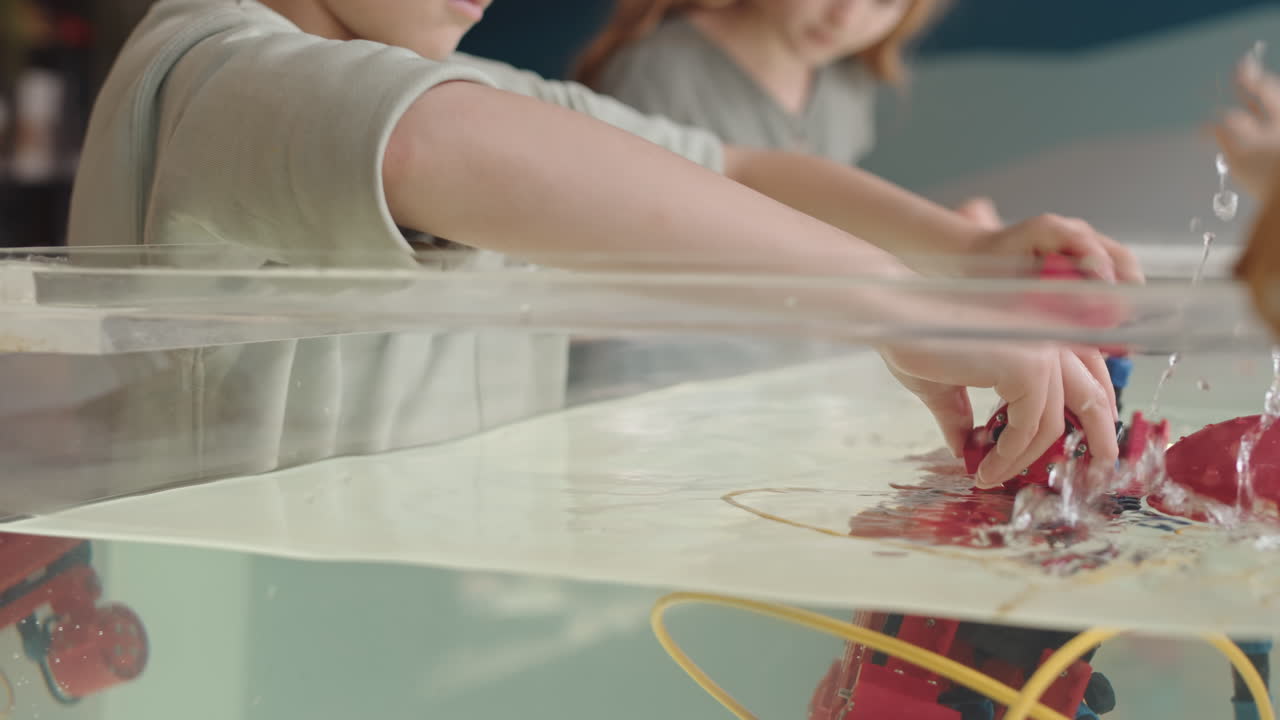 Kids Putting Robo Boat into Water