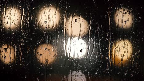 Various-shots-and-camera-movement-of-detailed-rain-drops-falling-on-window