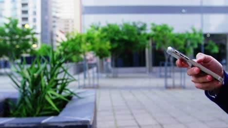 Businesswoman-text-messaging-on-mobile-phone