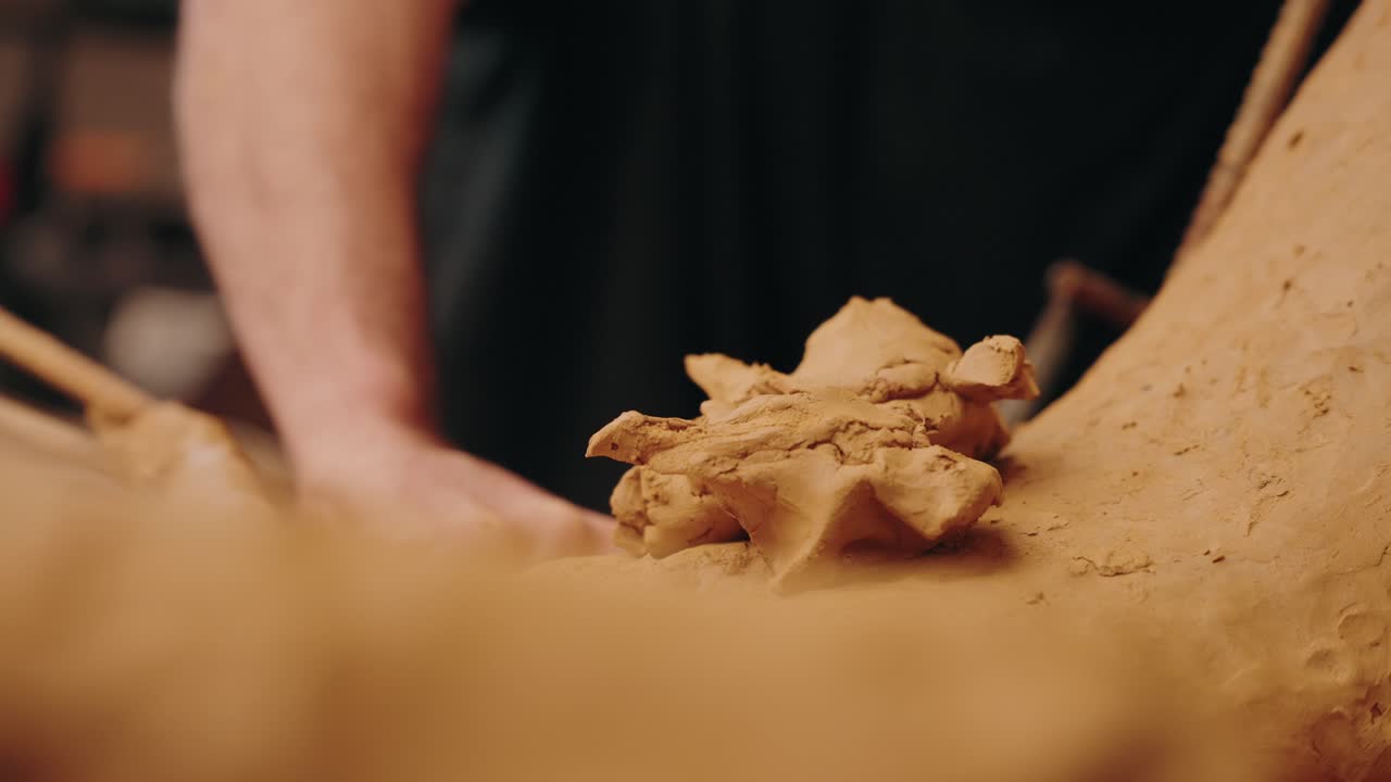 close up of hands molding soft clay with artistic focus