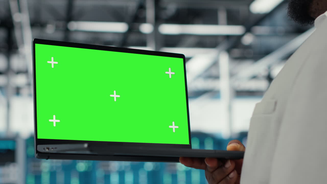 Technician upgrading equipment in data center using isolated screen laptop