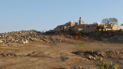 middle eastern graveyard and mosque drive by shot