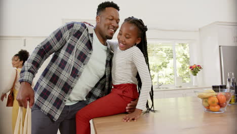 Happy-african-american-parents-and-daughter-with-shopping-bag-at-home,-slow-motion