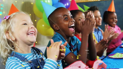 children clapping and laughing at party with confetti animation over them