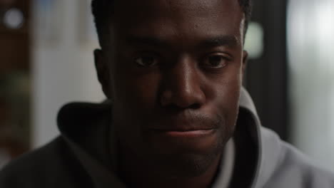 close up portrait shot of unhappy and depressed young man shaking head and shouting into camera