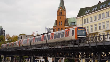 metro driving out of station on elevated tracks in city center