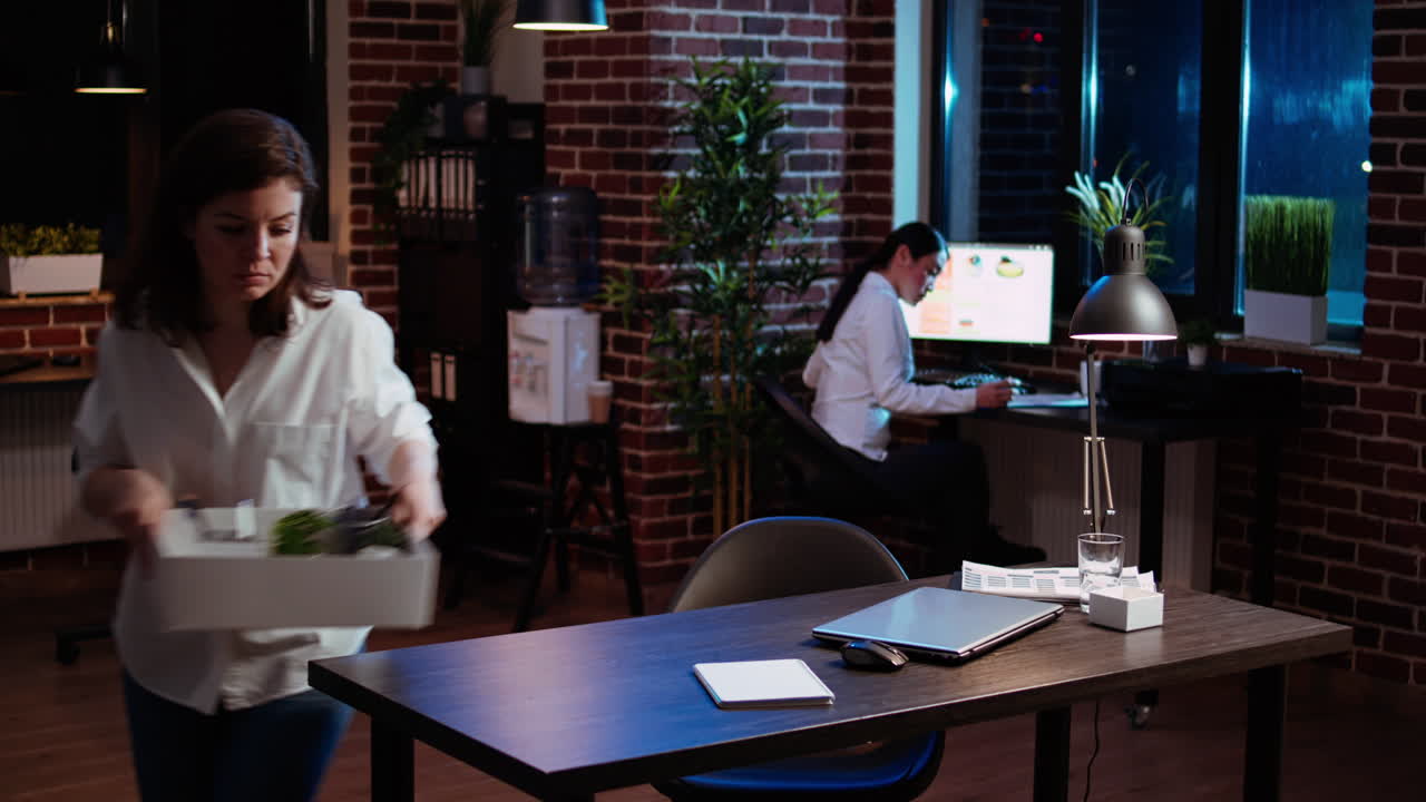 empleado frustrado empacando las pertenencias del escritorio después de ser despedido, diciendo adiós