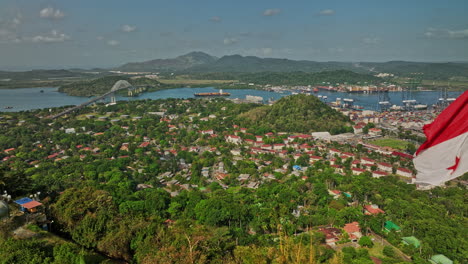 panama city aerial v68 fly-by waving panamanian flag on ancon hill overlooking la boca and balboa neighborhoods capturing port harbor, water canal and shipyard - shot with mavic 3 cine - march 2022