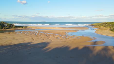 Aerial-View-Of-People-At-Sandy-Riverbed-Of-Moonee-Creek---Moonee-Beach-On-A-Sunny-Summer-Day-In-NSW,-Australia