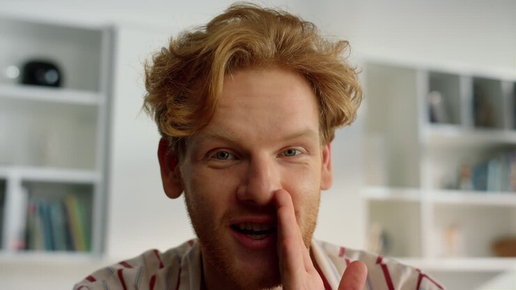 Happy guy enjoy conference at home closeup. Happy ginger husband telling secrets