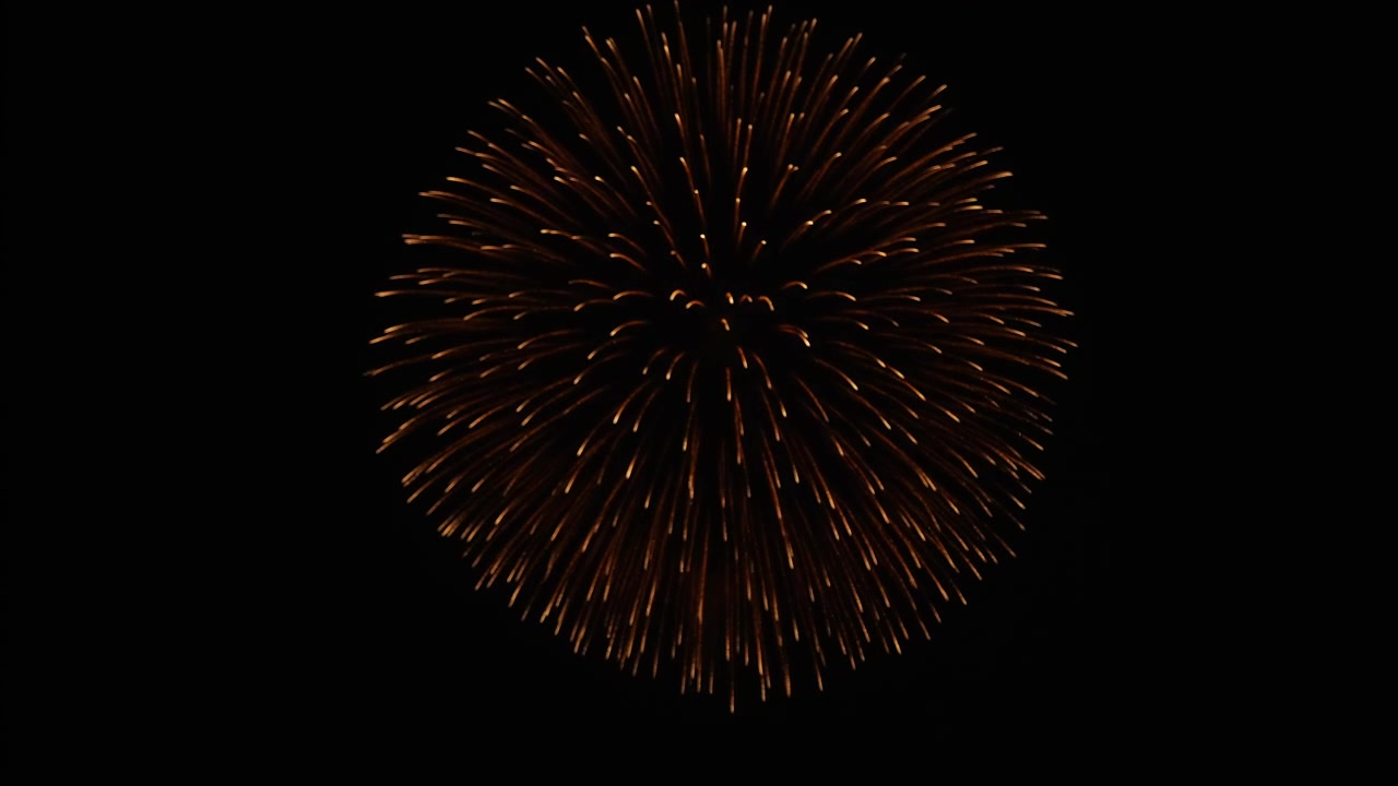 Intense golden firework explosion with blue core detail.