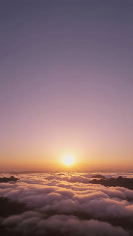 sunrise over misty mountains