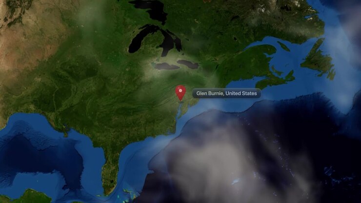 Satellite camera zooms from deep space orbit into Glen Burnie, Maryland with pin marker. Includes NASA public domain imagery.