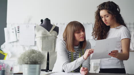 fashion designers collaborating on a design