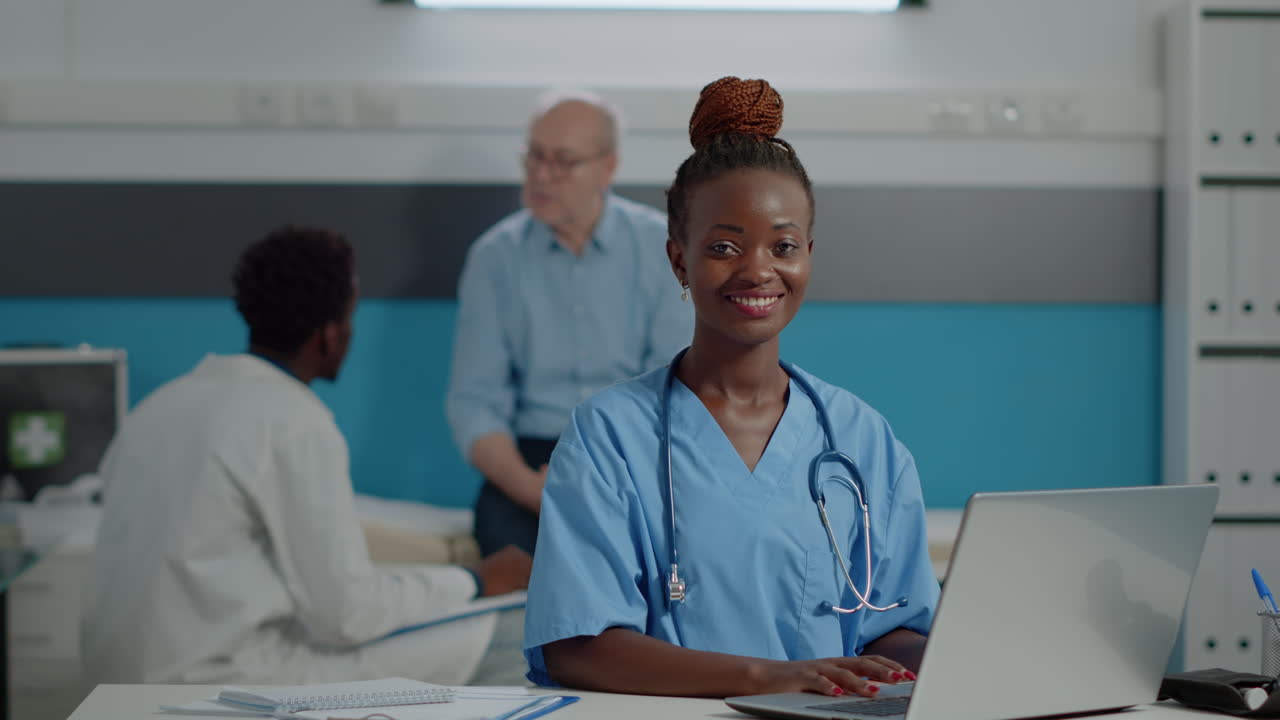 Portrait of nurse typing on laptop keyboard in medical office