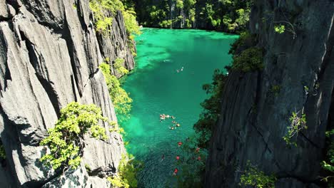 4k drone of swimmers in twin lagoon, coron, palawan philippines