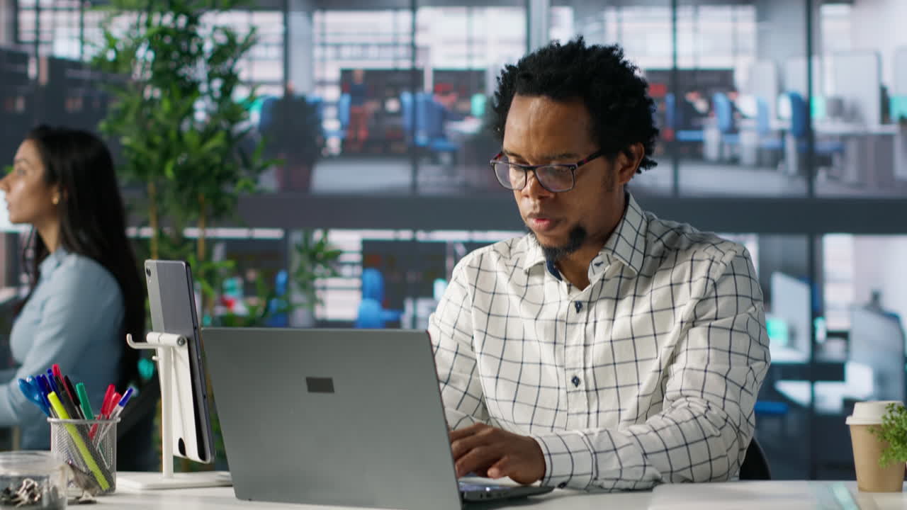 Professional Man Working on Laptop in Modern Office