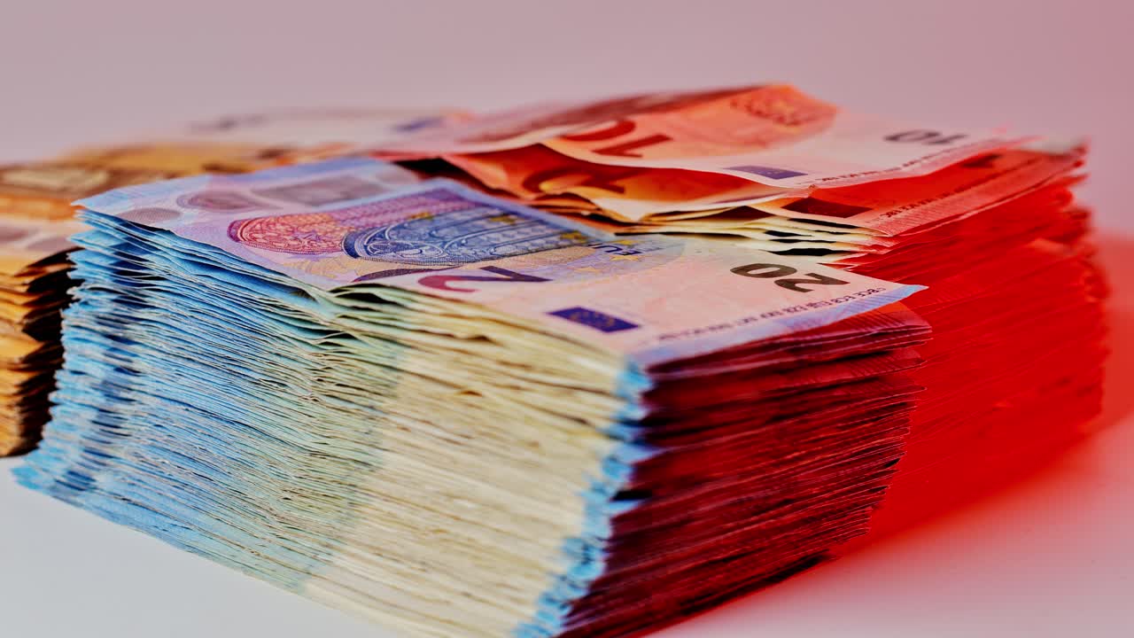 Color-lit euro cash piles evoke dramatic mood in symbolic wealth finance concept