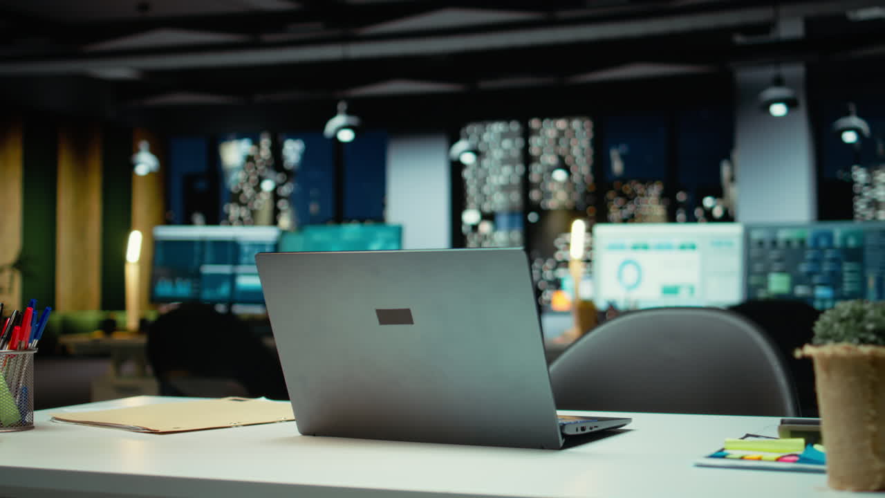 Modern empty office glows with performance metrics and forecasting graphs