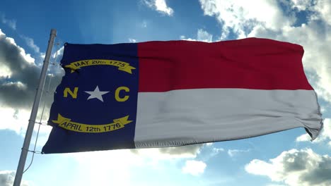 state flag of north carolina waving in the wind. blue sky background