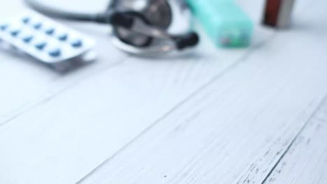 medical supplies and hand holding a medicine bottle