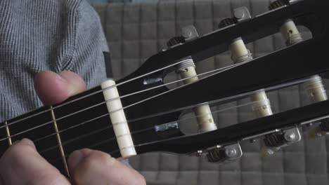 Playing guitar close up, truck shot