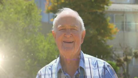 Animation-of-glowing-lights-over-smiling-senior-man-and-trees-in-background