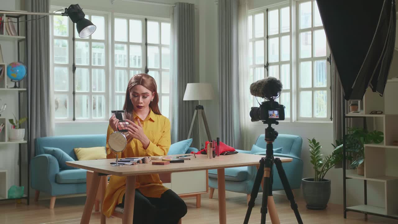 Influencer Young Transgender Man Blogger Talks About Makeup. Transgender Man Recording Video Blog Tells How To Be Beautiful. Blogger Talks Facial Beauty Treatments. Vlogger Broadcasts How To Use Of Cosmetic In Home Studio With Professional Lighting Equipment