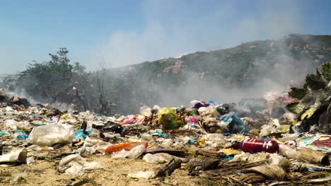 Pile-of-plastic-waste-in-garbage-dumb-landfill,-toxic-smoke-and-fire-burning-open-air-disposal-of-waste-materials,-pollution-ecological-disaster-pulmonary-disease