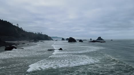 flyover of waves on the rocky indian beach in oregon on an overcast day