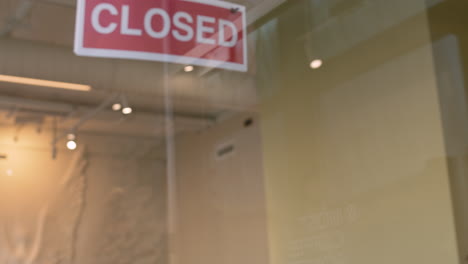 waiter putting an open sign on the coffee shop door 1