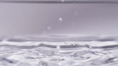 video of close up of drop of water with copy space on white background