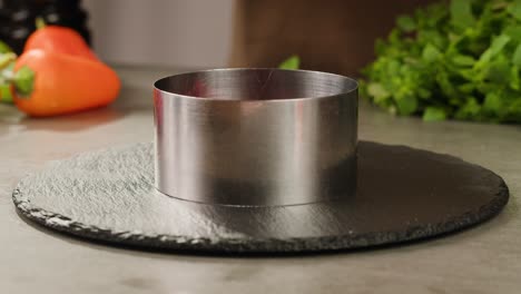 kitchen utensil - metal round cutter on slate