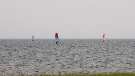 Wind Surfers Sailing on an Overcast Windy Day in the Distance in Pattaya, Thailand