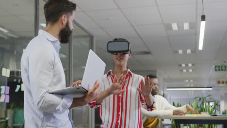 Happy-diverse-male-and-female-business-colleagues-using-vr-headset-in-office